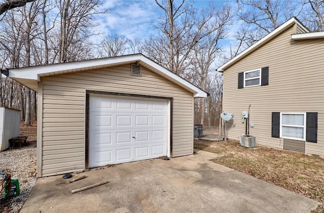 detached garage with cooling unit and driveway