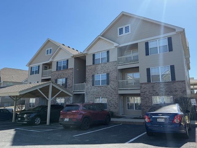 view of front of property with covered and uncovered parking