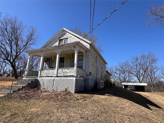 view of front of house with a porch and ac unit