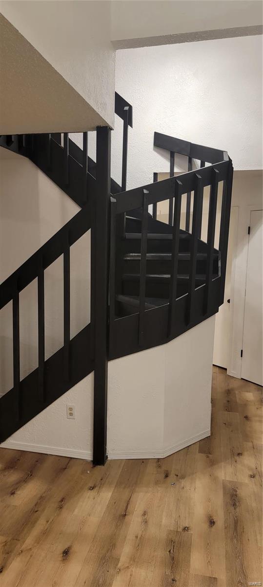 staircase with wood finished floors