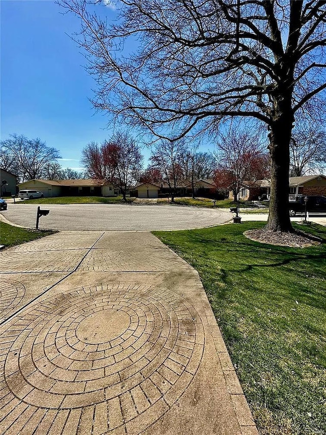 view of property's community with a lawn