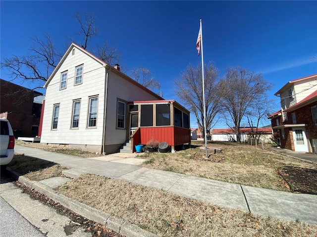 view of front facade with crawl space and a sunroom