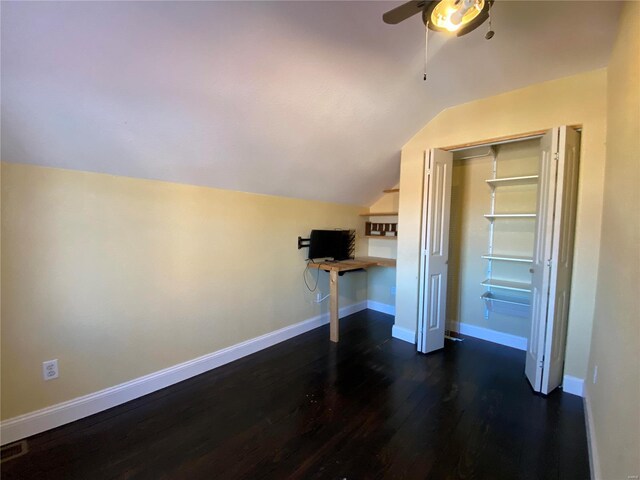 interior space featuring lofted ceiling, wood finished floors, baseboards, and ceiling fan