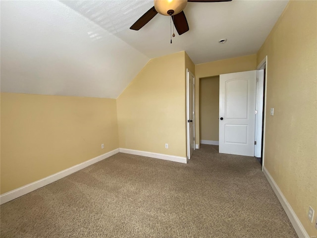 additional living space with lofted ceiling, carpet flooring, a ceiling fan, and baseboards