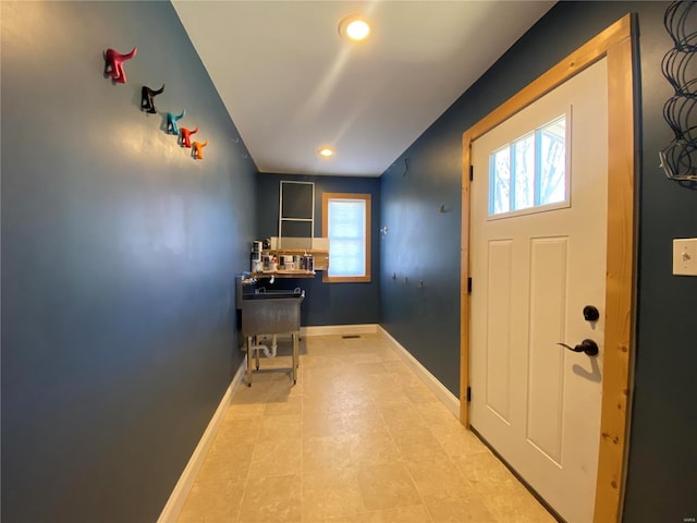 foyer entrance featuring recessed lighting and baseboards