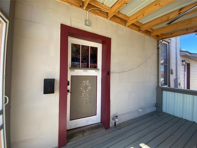 entrance to property with concrete block siding