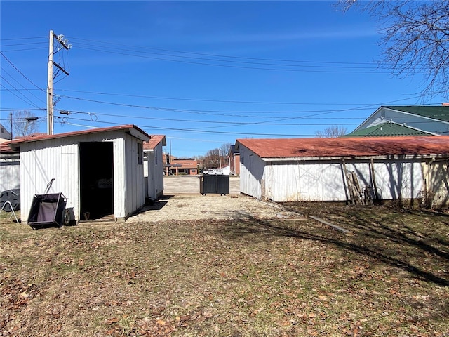 view of yard with a storage unit, an outbuilding, and fence