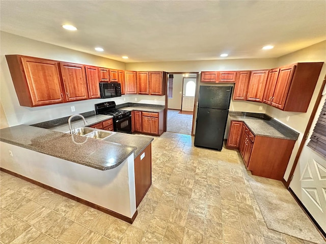 kitchen with black appliances, a sink, dark countertops, recessed lighting, and a peninsula