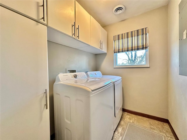 washroom with baseboards, visible vents, cabinet space, stone finish floor, and washer and dryer