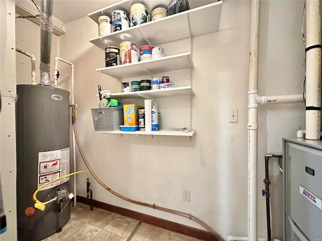 utility room featuring gas water heater