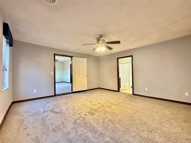 spare room with light colored carpet, baseboards, and ceiling fan