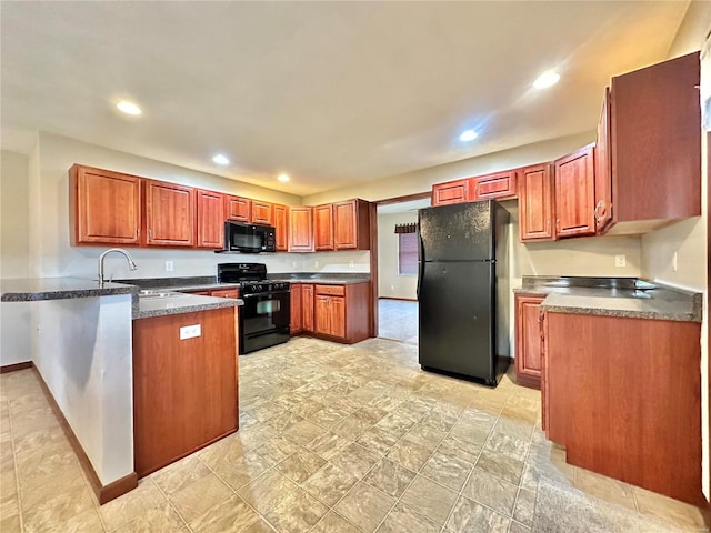 kitchen with black appliances, recessed lighting, dark countertops, and a sink