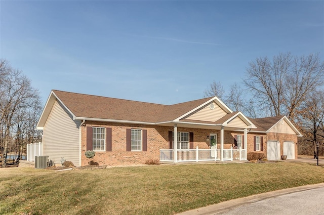 single story home with a front lawn, an attached garage, brick siding, and covered porch