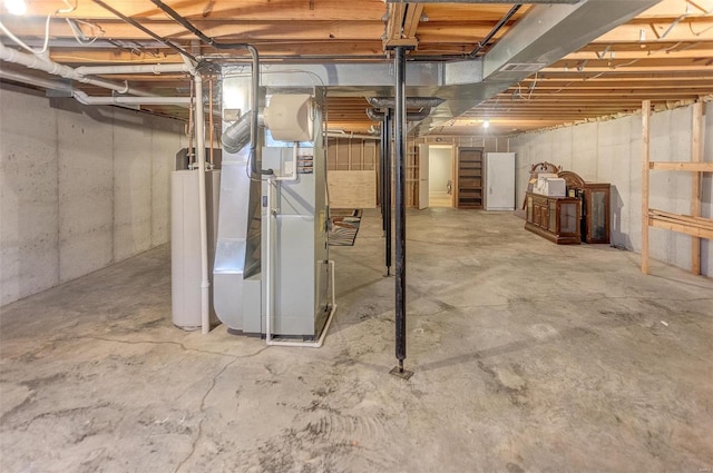 unfinished basement featuring gas water heater and heating unit