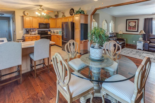 dining area featuring light wood-style flooring and ceiling fan