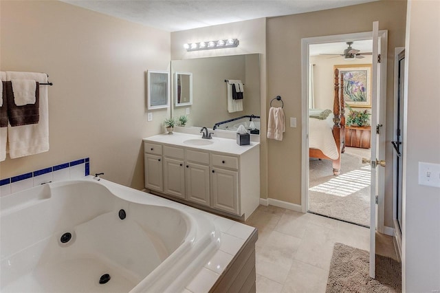 ensuite bathroom with vanity, baseboards, ensuite bath, tile patterned flooring, and a garden tub