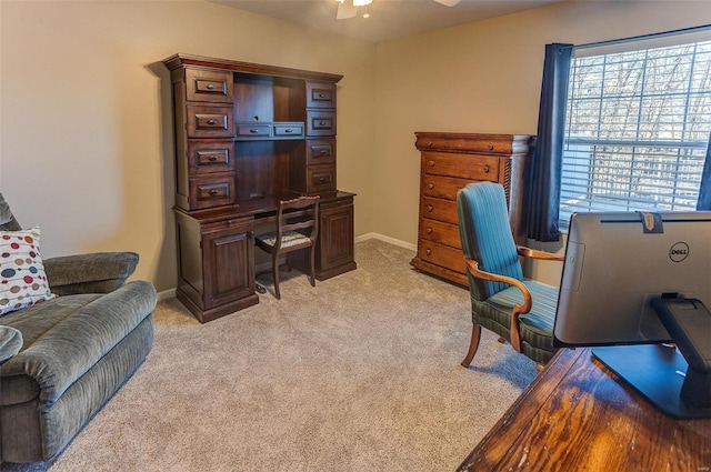 office with a ceiling fan, baseboards, and light carpet