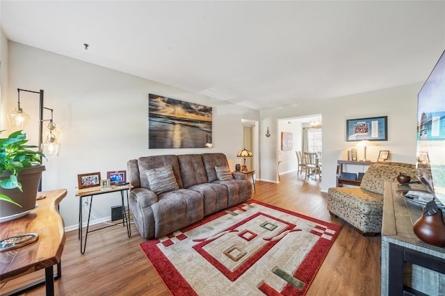 living room featuring baseboards and wood finished floors