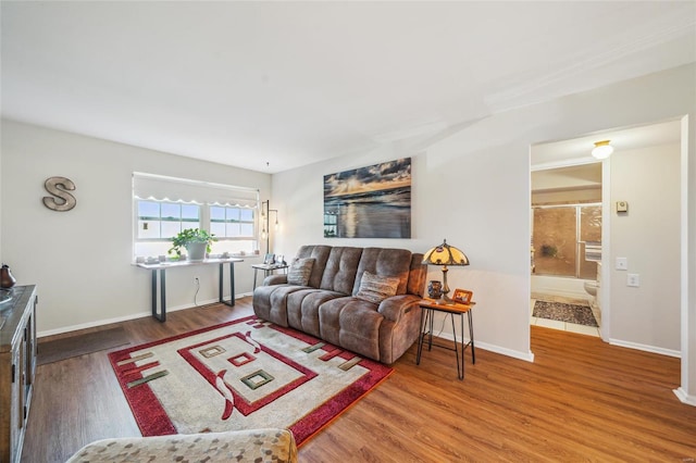 living room with wood finished floors and baseboards