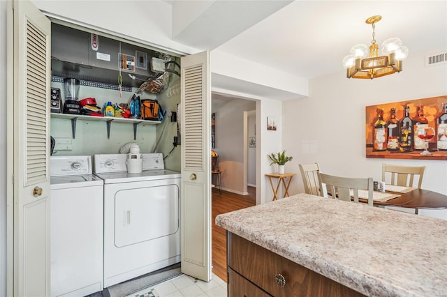 laundry room featuring a chandelier, laundry area, washing machine and dryer, and visible vents