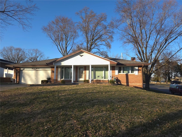 view of front of property featuring driveway, an attached garage, a chimney, a front lawn, and brick siding