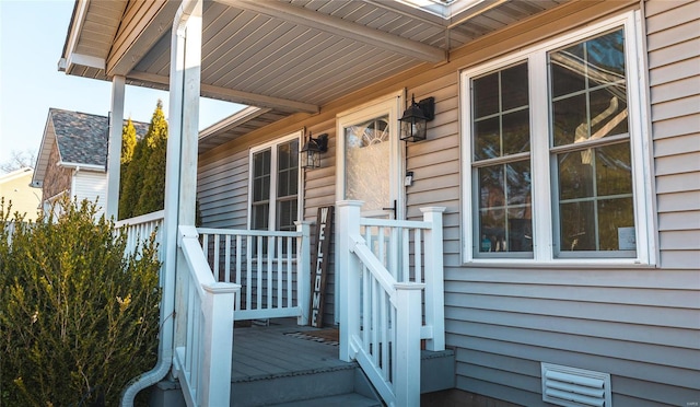 doorway to property featuring visible vents and covered porch