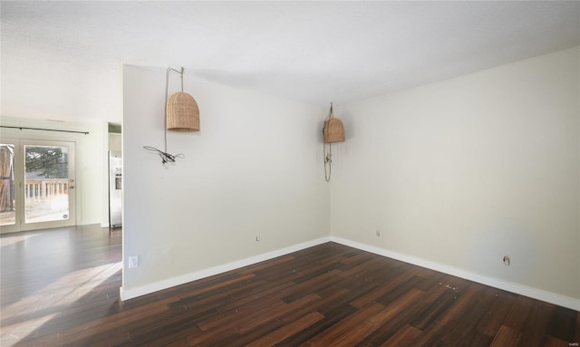 unfurnished room featuring dark wood finished floors and baseboards