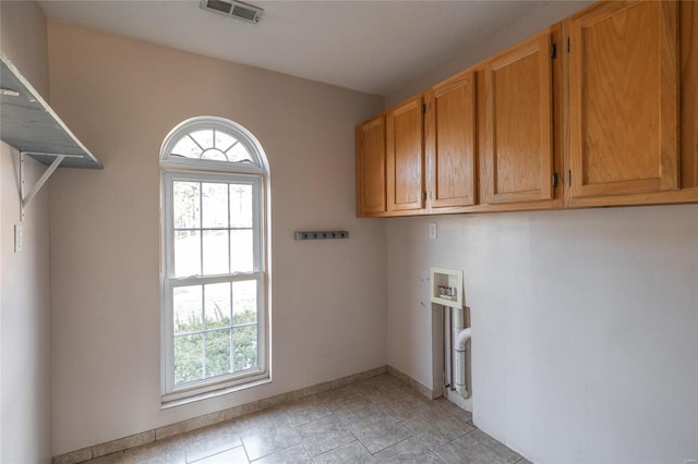 clothes washing area featuring hookup for a washing machine, light tile patterned floors, visible vents, baseboards, and cabinet space