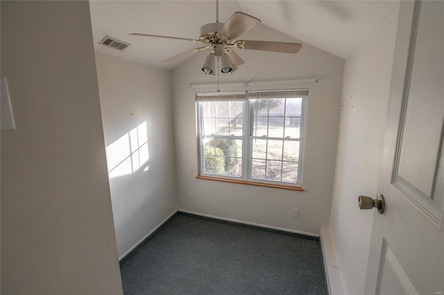 empty room featuring visible vents, baseboards, vaulted ceiling, a ceiling fan, and dark colored carpet