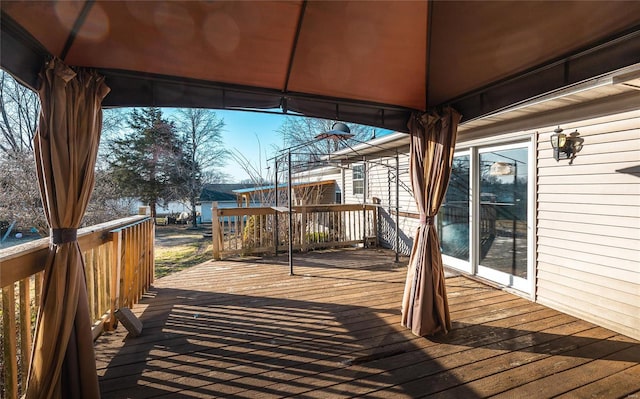 wooden terrace featuring a gazebo