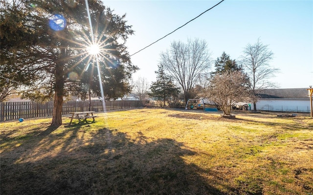 view of yard featuring a playground and fence