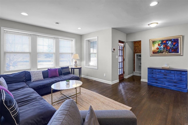 living room with recessed lighting, visible vents, baseboards, and wood finished floors