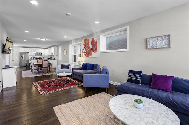 living area with dark wood-style floors, recessed lighting, and baseboards