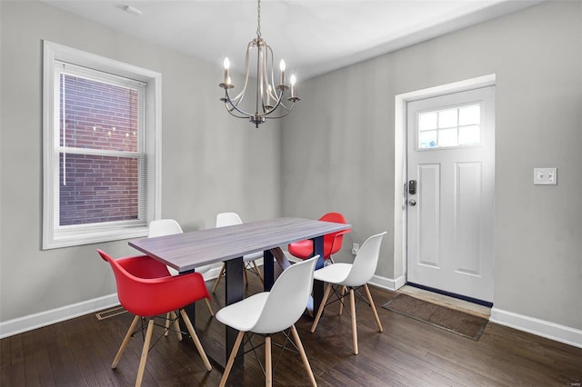 dining area with visible vents, baseboards, a notable chandelier, and wood-type flooring