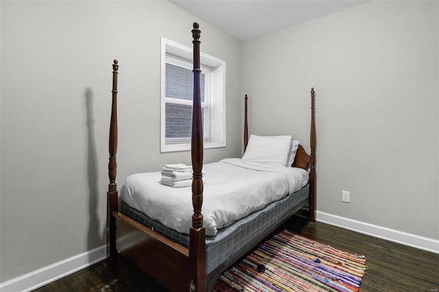 bedroom with wood finished floors and baseboards