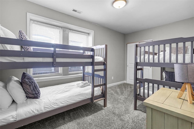 carpeted bedroom featuring baseboards and visible vents