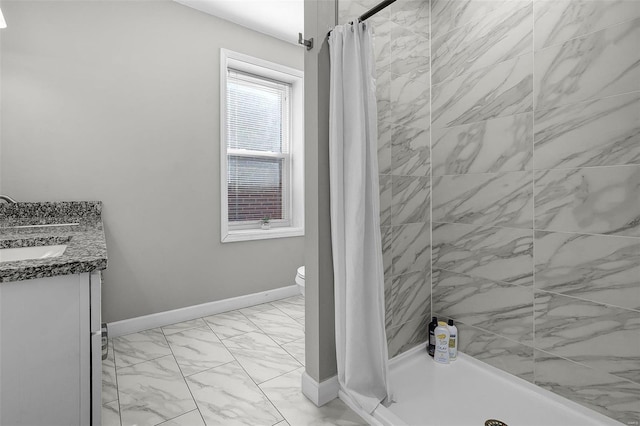 bathroom featuring a shower stall, baseboards, and marble finish floor