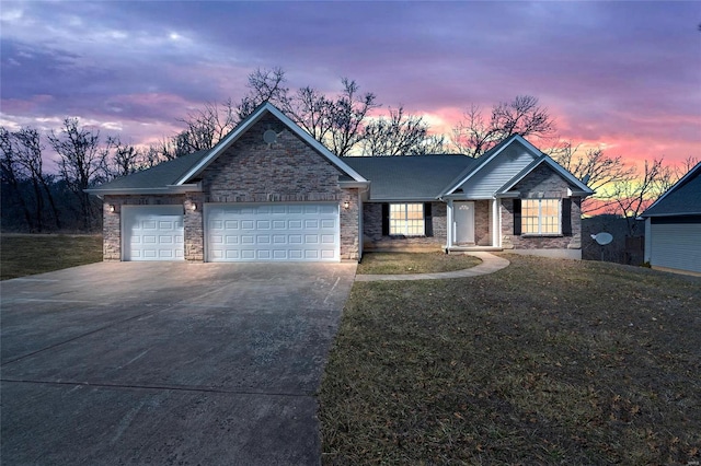 ranch-style home with concrete driveway, a garage, and a front lawn