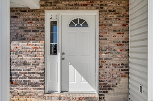 property entrance with brick siding