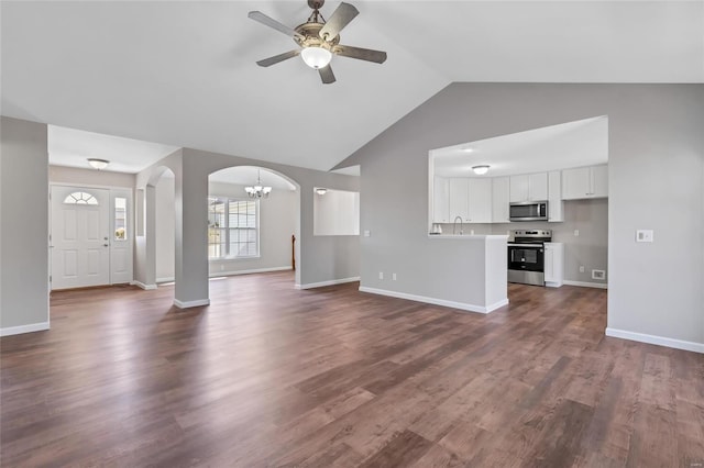 unfurnished living room featuring baseboards, dark wood finished floors, lofted ceiling, ceiling fan with notable chandelier, and arched walkways