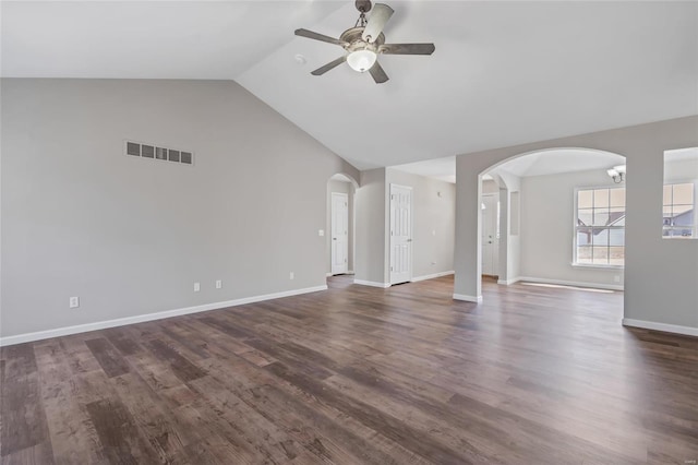 unfurnished living room featuring dark wood-style floors, visible vents, arched walkways, ceiling fan, and vaulted ceiling