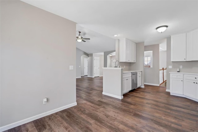 kitchen featuring baseboards, arched walkways, stainless steel dishwasher, and ceiling fan