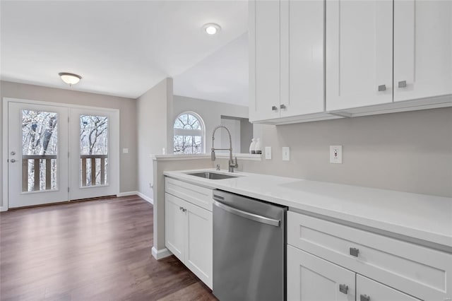 kitchen with a sink, white cabinetry, stainless steel dishwasher, and light countertops