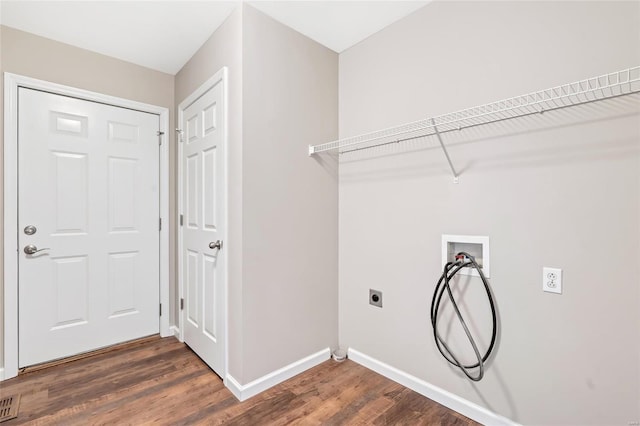 clothes washing area with washer hookup, laundry area, dark wood-style floors, and baseboards