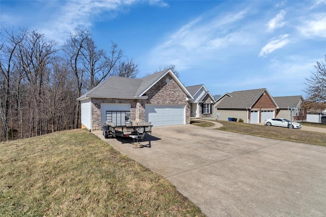 view of front of home with a garage, a front yard, brick siding, and driveway