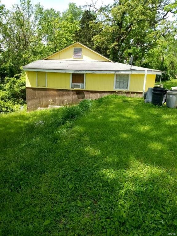 back of property featuring a yard