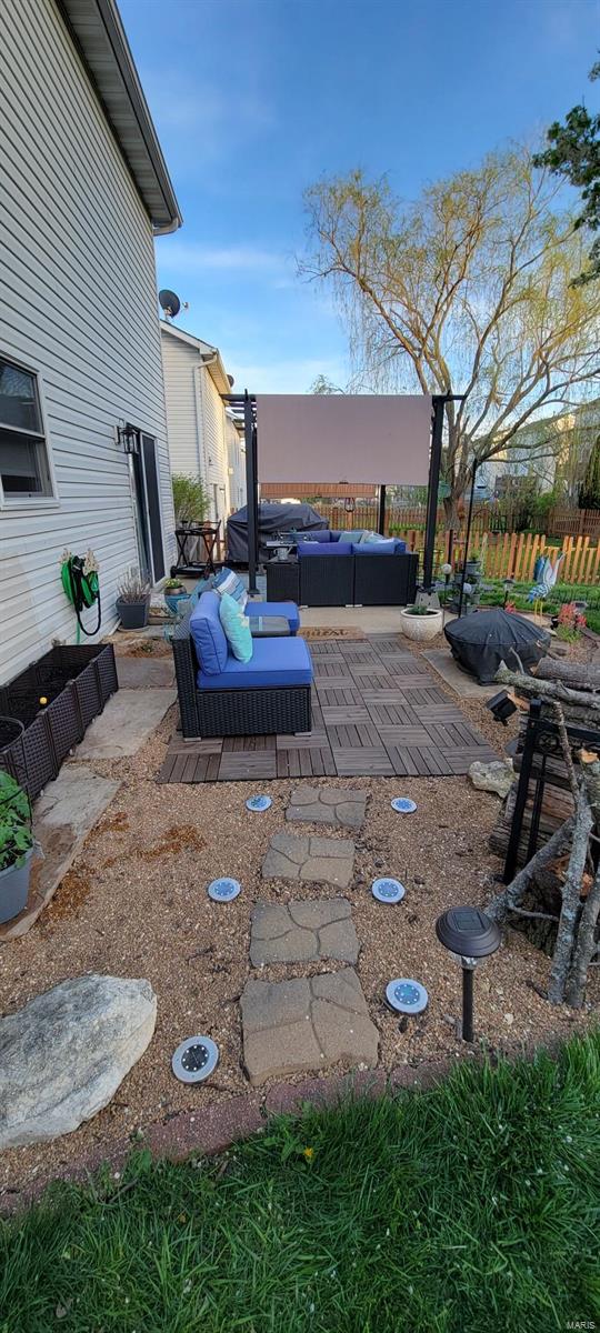 view of yard featuring an outdoor hangout area, a patio, and fence