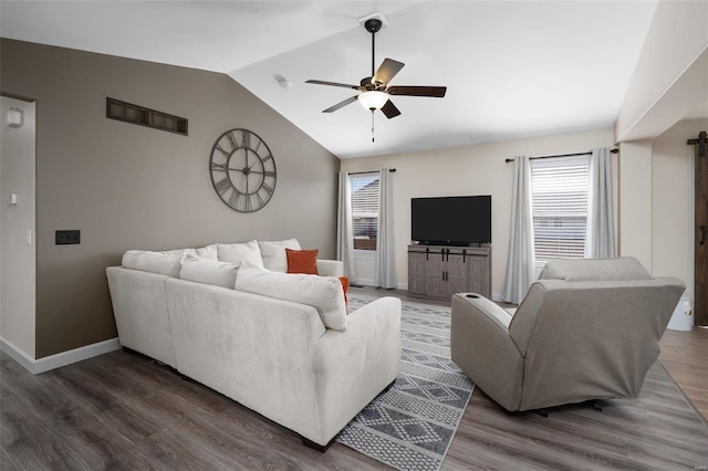 living room featuring wood finished floors, a ceiling fan, baseboards, visible vents, and lofted ceiling