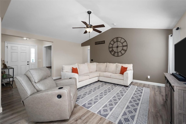 living room with baseboards, wood finished floors, ceiling fan, and vaulted ceiling