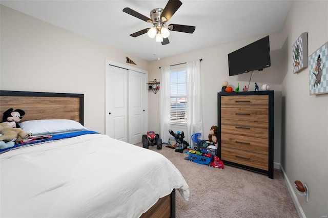 bedroom with a closet, baseboards, carpet floors, and ceiling fan